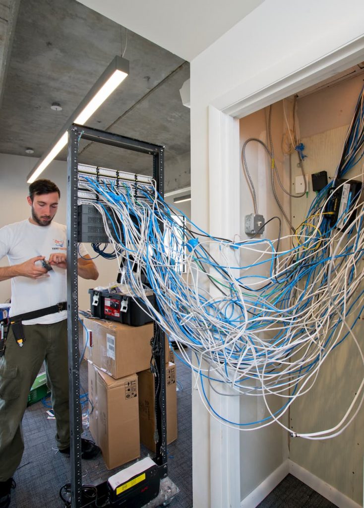 Network support staff working on server wiring